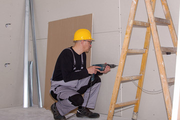 Construction worker assembling plaster column