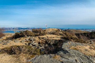 Fototapeta na wymiar Remains of old fortifications on top of the small hill in Snode suburb with Hafsfjord fjord on background, Tananger, Norway, March 2018