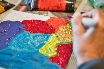 Older woman painting at home for entertainment