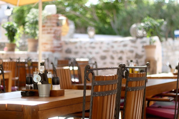 Wooden furniturein a garden of Mediterranean restaurant. Selective focus.