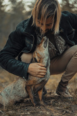 Young man with a wild fox