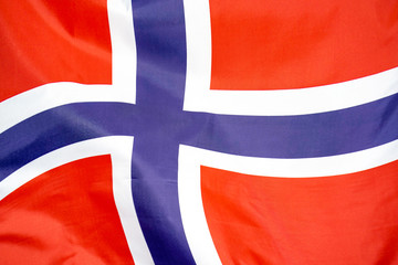 Fabric texture flag of Norway. Flag of Norway waving in the wind. Norway flag is depicted on a sports cloth fabric with many folds. Sport team banner.