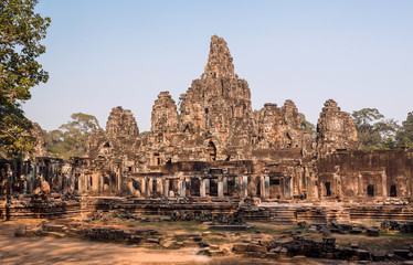 Fototapeta na wymiar Towers and walls of the 12th century Bayon temple, Cambodia. Historical landmark in Angkor. UNESCO world heritage site