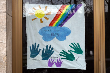 Europe, Italy, Milan - Flash mob, children and families draw rainbow and scirtta Everything will go well on house windows - Pandemic emergency n-cov19 Coronavirus