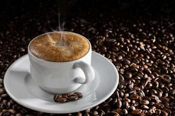white cup with hot grain coffee, on a dark background
