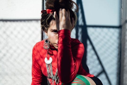 Charming Colombian woman holding head