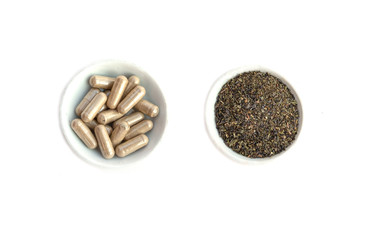 capsule and powder in white bowl on kratom leaf (Mitragyna speciosa) Mitragynine on wooden ,Drugs and Narcotics,Thai herbal which encourage health