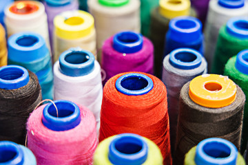 Pile of sewing spools with threads