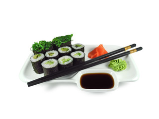 Vegetarian sushi roll with avocado, cucumber and kelp seaweed on plate with wasabi, ginger, soy sauce and  black-golden chopsticks isolated on white background.   
