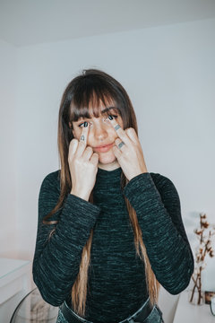Portrait of woman making sign of flip the bird with her hands