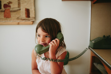 girl talks on old school phone