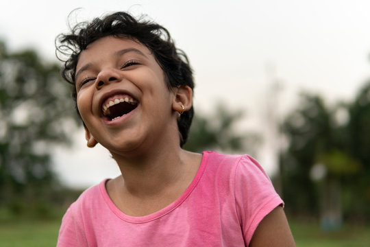 Cute girl making fun and laughing at outdoors