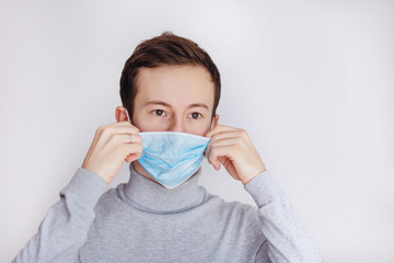 Protection against contagious disease, coronavirus. Man wearing hygienic mask to prevent infection, airborne respiratory illness such as flu, 2019-nCoV. indoor studio shot isolated on white background