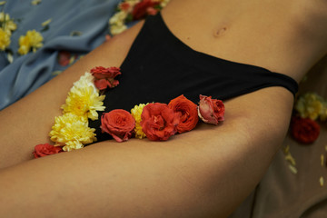 woman legs in black underwear with beautiful flowers