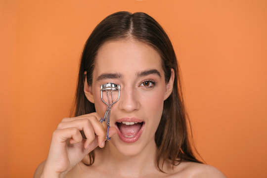 Woman Using Eyelashes Curler