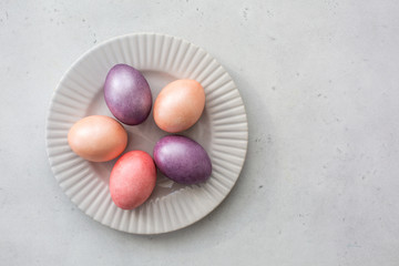 Easter eggs painted in pastel colours. Copy space. Top view. Natural light.