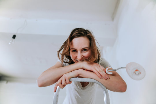 Young funny girl doing repairs