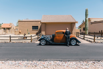 Fancy Custom Car with Owner Outside of his home