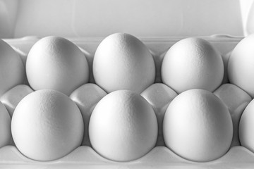 White chicken eggs close-up on a white background top view. Great Easter.