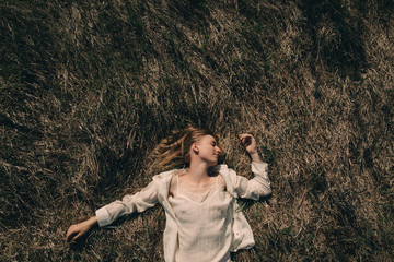 Smiling woman lying on grass