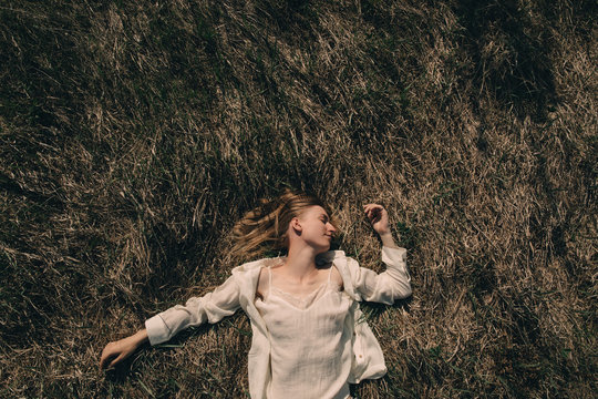 Smiling woman lying on grass