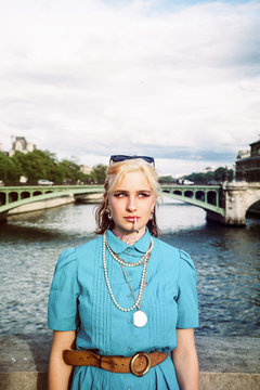 Young woman in colorful style on a bridge in Paris