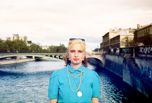 Young woman in colorful style on a bridge in Paris