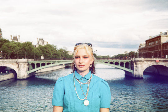 Young woman in colorful style on a bridge in Paris