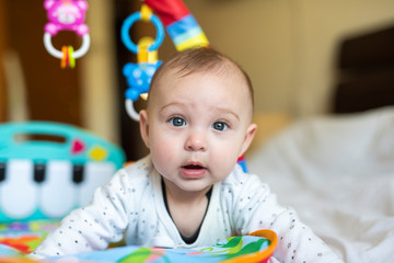 Cute six month baby playing on the bed