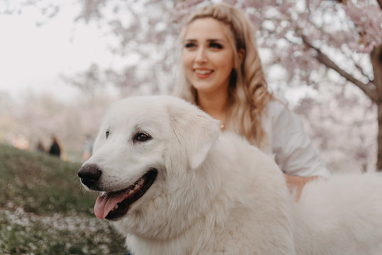 A beautiful young woman holding her dog