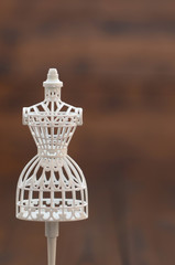 White female vintage Mannequin stand on a wooden background, fashion design concept