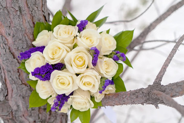 Bride's bouquet of light yellow roses close-up in winter.