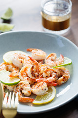 Fried tiger shrimp with lime, lemon and spices on a ceramic dish. Healthy dinner or lunch concept.