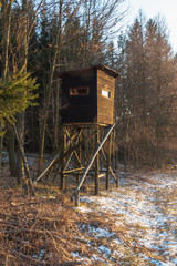 Hunting tower in wild forest. Wooden Hunter Hide High watch post tower. Hunter's observation point...