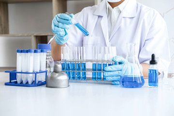 Biochemistry laboratory research, Chemist is analyzing sample in laboratory with equipment and...
