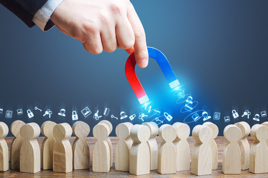 A hand with a magnet collects personal data passwords from crowd people. Collection personal information, Spying surveillance on Internet users. Theft of databases. Advertising marketing and targeting