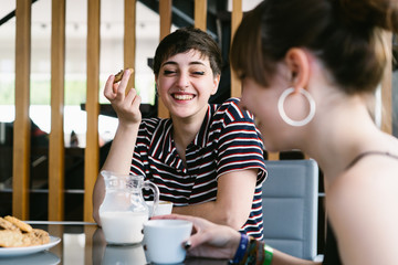 Two Friends Laughing During Breakfast.