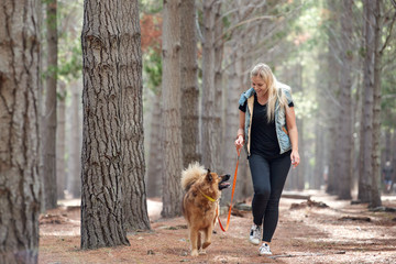 Happy pet owner and dog on walk