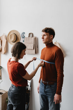Dressmaker doing measure by centimeter tape.