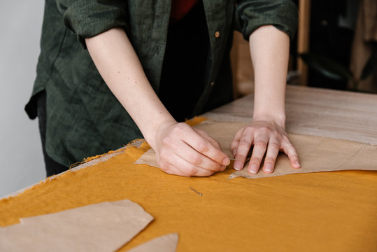 cropped tailor hands attaching paper template