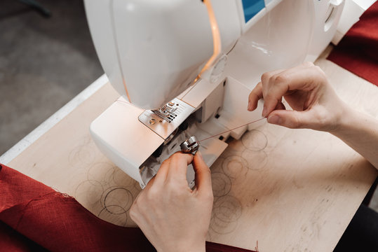 Woman working with patterns of paper.