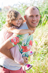 pretty little girl with dad on nature