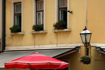 Historic architecture and traditional red parasol in uptown Zagreb, Croatia.