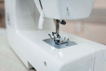 Part of the white sewing machine close-up. Shuttle a needle