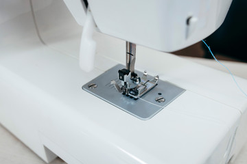 Part of the white sewing machine close-up. Shuttle a needle