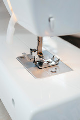 Part of the white sewing machine close-up. Shuttle a needle