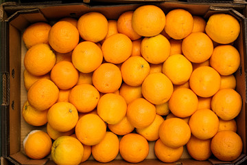ripe oranges in a box on the market