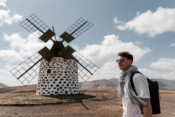 Handsome man traveling and looking famous places.