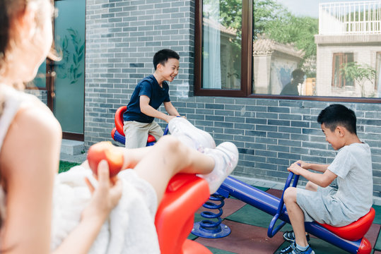 Kids riding a small teeter totter