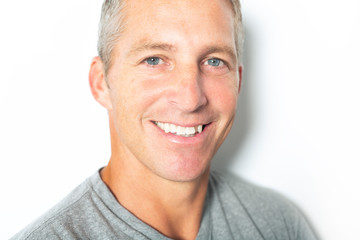 Fototapeta premium Portrait of confident mature man standing on white background